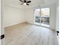 Spacious bedroom with wood-look floors and access to private balcony at 4899 S Dudley # 1I, Littleton, CO 80123