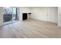 Bright living room with wood-look floors and sliding glass door to patio at 4899 S Dudley # 1I, Littleton, CO 80123