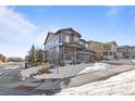 Two-story home with a covered porch, three car garage and mixed stone and horizontal siding at 8104 El Jebel Loop, Castle Rock, CO 80108