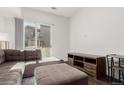 Comfortable living room with a brown sectional couch and sliding glass door to the patio at 2876 W 53Rd Ave # 111, Denver, CO 80221