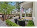 Exterior yard featuring a covered porch, lush landscaping, and a charming fence at 4508 Lowell Blvd, Denver, CO 80211