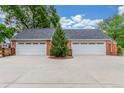 Spacious three car garage featuring two bays with white doors at 3 Glenview Dr, Littleton, CO 80123