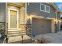 Close up of craftsman style home featuring a three-car garage, and stone accents at 23696 E Del Norte Pl, Aurora, CO 80016