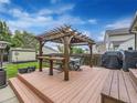 Outdoor dining on deck with pergola includes a table with seating and a barbecue grill with serving area at 11395 E 116Th Dr, Commerce City, CO 80640