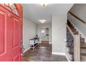 Welcoming foyer with beautiful tile flooring, a staircase with iron railings, and a view into the kitchen at 35427 Welch Trl, Elizabeth, CO 80107