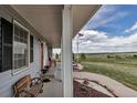 Scenic view from the front porch overlooking the expansive landscape and an American flag waving proudly in the distance at 35427 Welch Trl, Elizabeth, CO 80107