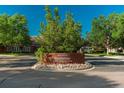 Attractive brick sign for the 'Riverwalk Clubhouse' is surrounded by landscaping and well kept lawns at 2896 W Riverwalk Cir # 204, Littleton, CO 80123