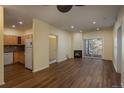 Bright living room featuring wood floors, fireplace, access to the balcony and open to the kitchen at 2896 W Riverwalk Cir # 204, Littleton, CO 80123
