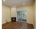 Living room with a cozy fireplace and a sliding glass door leading to the balcony at 2896 W Riverwalk Cir # 204, Littleton, CO 80123