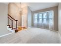 Bright living room featuring hardwood floors and a staircase at 2368 W 119Th Ave, Denver, CO 80234