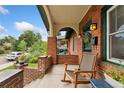 Inviting front porch with a rocking chair perfect for enjoying quiet moments outside at 1215 Jackson St, Denver, CO 80206