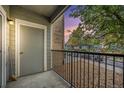 A cozy balcony offers a private outdoor space with a view of the surrounding neighborhood and colorful sunset at 4451 S Ammons St # 4-108, Littleton, CO 80123