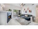 Comfortable living room features a sleek fireplace, plush seating, and natural light from the sliding glass door at 4451 S Ammons St # 4-108, Littleton, CO 80123