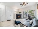 Inviting living room with a modern fireplace, comfortable seating, and access to a private balcony for relaxation at 4451 S Ammons St # 4-108, Littleton, CO 80123