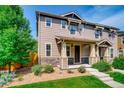 Two-story townhome with front porch and landscaping at 1567 S Dallas Cir, Denver, CO 80247