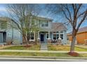 Inviting two-story home with a cozy front porch, stone accents and well-maintained lawn at 14214 Lakeview Ln, Broomfield, CO 80023