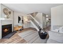 Bright living room featuring a fireplace, staircase, and open floor plan at 9636 W Chatfield Ave # C, Littleton, CO 80128