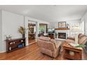 Comfortable living room with a fireplace, plush seating, and hardwood floors at 2181 E Phillips Ln, Centennial, CO 80122