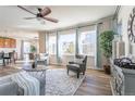 Spacious living area with hardwood floors and natural light, seamlessly connected to the dining area at 1135 Basalt Ridge Loop, Castle Rock, CO 80108
