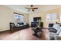 Spacious living room featuring hardwood floors, a ceiling fan, and lots of natural light at 25126 E Bayaud Pl, Aurora, CO 80018