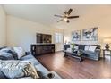 Cozy living room with hardwood floors, stylish furnishings, and a modern ceiling fan at 25126 E Bayaud Pl, Aurora, CO 80018