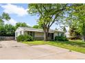 Ranch style home with mature landscaping and lawn and a concrete driveway at 4616 E Yale Ave, Denver, CO 80222