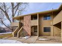 The exterior of this condo features painted wood facade, brick details, and dual private balconies at 1120 Bacchus Dr # B16, Lafayette, CO 80026