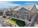 Landscaped backyard with wood fence, small patio, artificial turf area, and stone walkway to the main house at 8099 Arapahoe Peak St, Littleton, CO 80125
