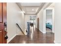 Elegant entryway with hardwood floors and tray ceiling detail at 8099 Arapahoe Peak St, Littleton, CO 80125