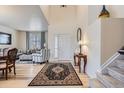 Bright foyer with hardwood floors, a staircase, and an area rug adding warmth to the entry at 10551 Redcone Way, Highlands Ranch, CO 80130