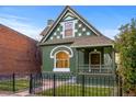 Charming green Victorian home with a front porch at 2521 Champa St, Denver, CO 80205