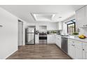 Bright kitchen with stainless steel appliances, white cabinets, and a skylight at 12662 E Warren Dr # F, Aurora, CO 80014