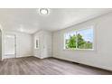 Bright living room featuring fresh paint, new trim, durable laminate floors, and great natural light at 1032 Geneva, Aurora, CO 80010