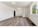 Spacious living room with fresh paint, laminate flooring, and natural light at 1032 Geneva, Aurora, CO 80010