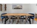 Dining room with a light wood table, metal chairs, and an eye-catching mountain artwork at 6314 Brooks Dr, Arvada, CO 80004