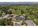 Expansive aerial view of the property, showcasing the home, landscaping, pool, and surrounding acreage at 13962 W 76Th Ln, Arvada, CO 80005