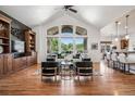 Bright living room with vaulted ceilings, large windows, hardwood floors, and stylish furnishings at 13962 W 76Th Ln, Arvada, CO 80005