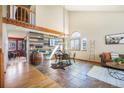 Spacious living room area featuring a decorative accent wall, large windows and tile flooring, and an elegant decor at 10873 W 84Th Pl, Arvada, CO 80005