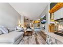 Open living space with wood floors, stone fireplace, and a view to the kitchen at 434 Kings Crown Rd, Breckenridge, CO 80424