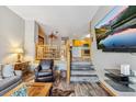 Inviting living room with flat screen TV and steps to kitchen and dining area at 434 Kings Crown Rd, Breckenridge, CO 80424
