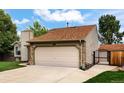 Exterior view of a two-car garage, showing the home's driveway and gated entrance at 5101 E 122Nd Cir, Thornton, CO 80241