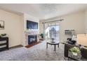 Living room features a fireplace, balcony access, and ample natural light at 2225 S Jasmine St # 304, Denver, CO 80222
