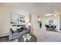 Open living and dining area with neutral decor and modern furniture at 2225 S Jasmine St # 304, Denver, CO 80222