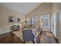 Bright living room with vaulted ceilings, large windows, and hardwood floors at 1246 E Phillips Pl, Littleton, CO 80122