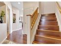Inviting entryway features hardwood floors, staircase with wooden railing, and neutral decor at 3000 E 112Th Ave # 86, Northglenn, CO 80233