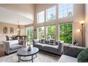 Well-lit living area with a dining table visible, hardwood floors and multiple gray sofas at 3000 E 112Th Ave # 86, Northglenn, CO 80233