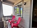 Charming patio featuring two bright red Adirondack chairs and scenic views at 4788 Laurelglen Ln, Highlands Ranch, CO 80130