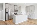 Modern kitchen with stainless steel appliances, an island, and sleek gray cabinets at 17942 E 94Th Pl, Commerce City, CO 80022