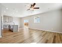 Open-concept living room featuring hardwood floors, recessed lighting, and sliding doors to backyard at 17942 E 94Th Pl, Commerce City, CO 80022