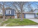 Charming split level home with a brick and blue siding, complemented by a well-manicured lawn at 9921 Wigham St, Thornton, CO 80229
